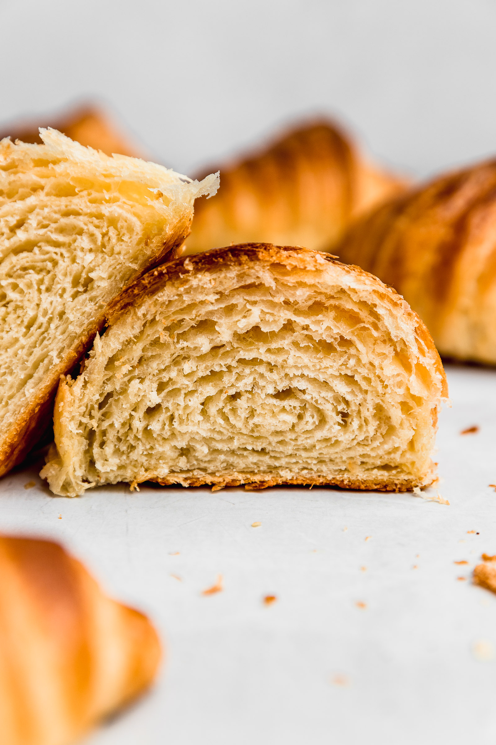 Cross section of a homemade buter croissant, with pockets and flaky layers of air and dough.